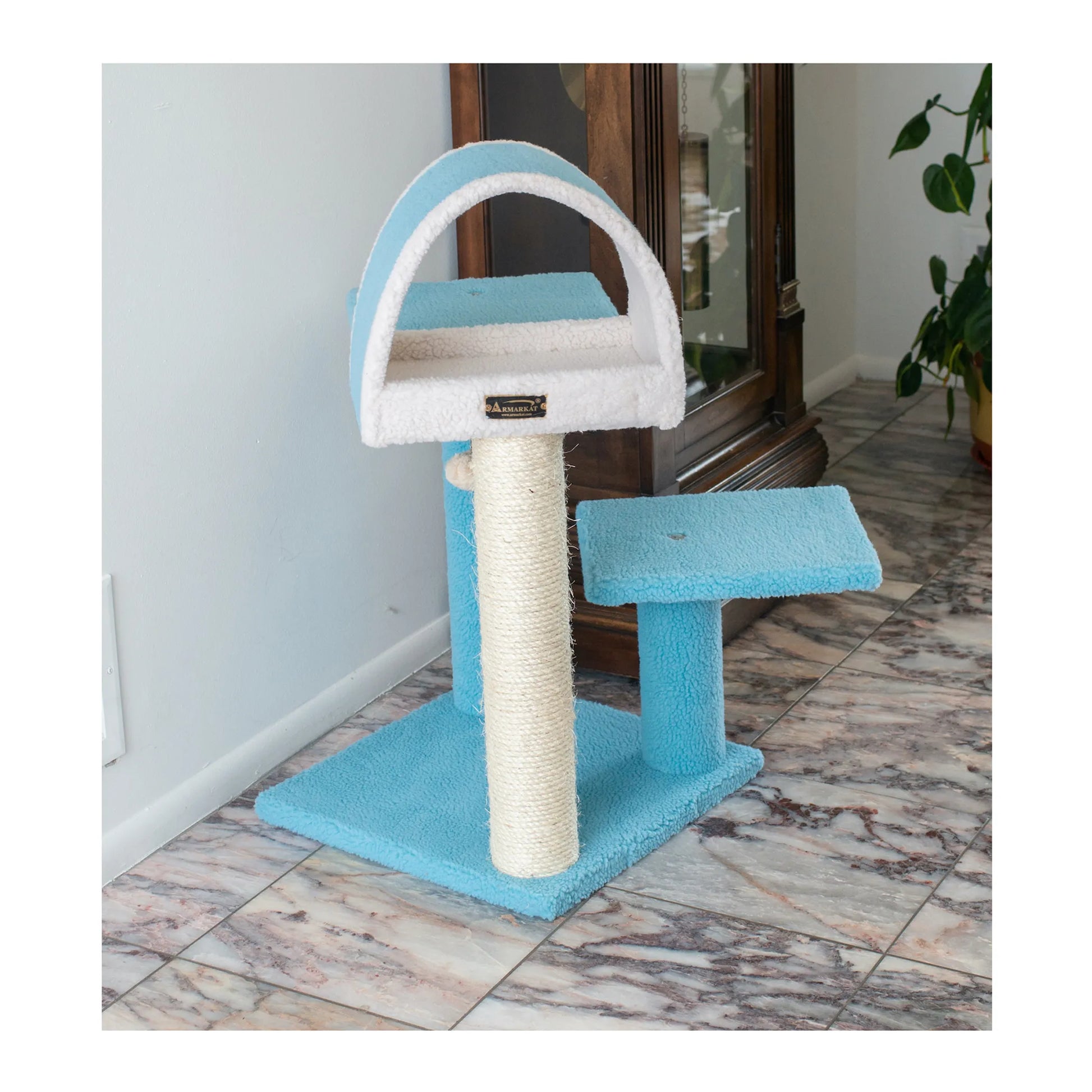 Blue and white cat tree with a scratching post on a marble floor.
