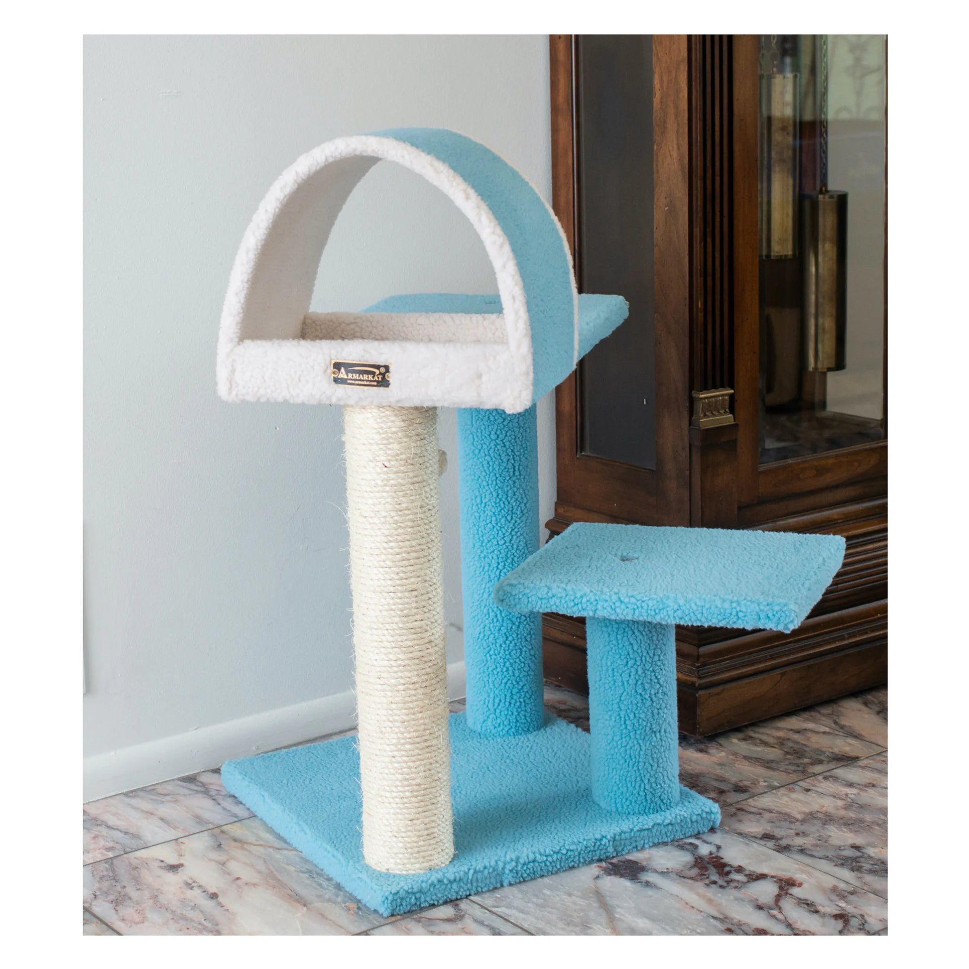Blue and white cat tree with a scratching post on a marble floor.