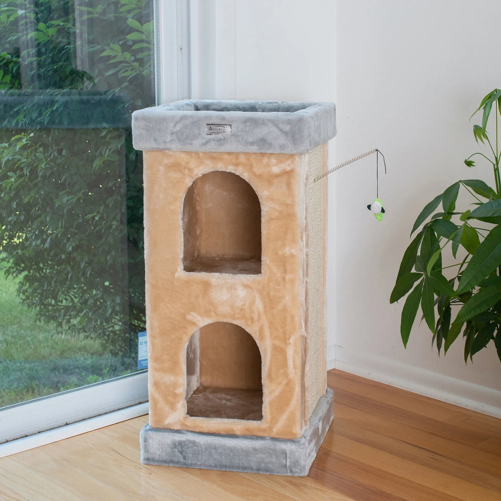 Cat tree with multiple levels in a room with a window and plant