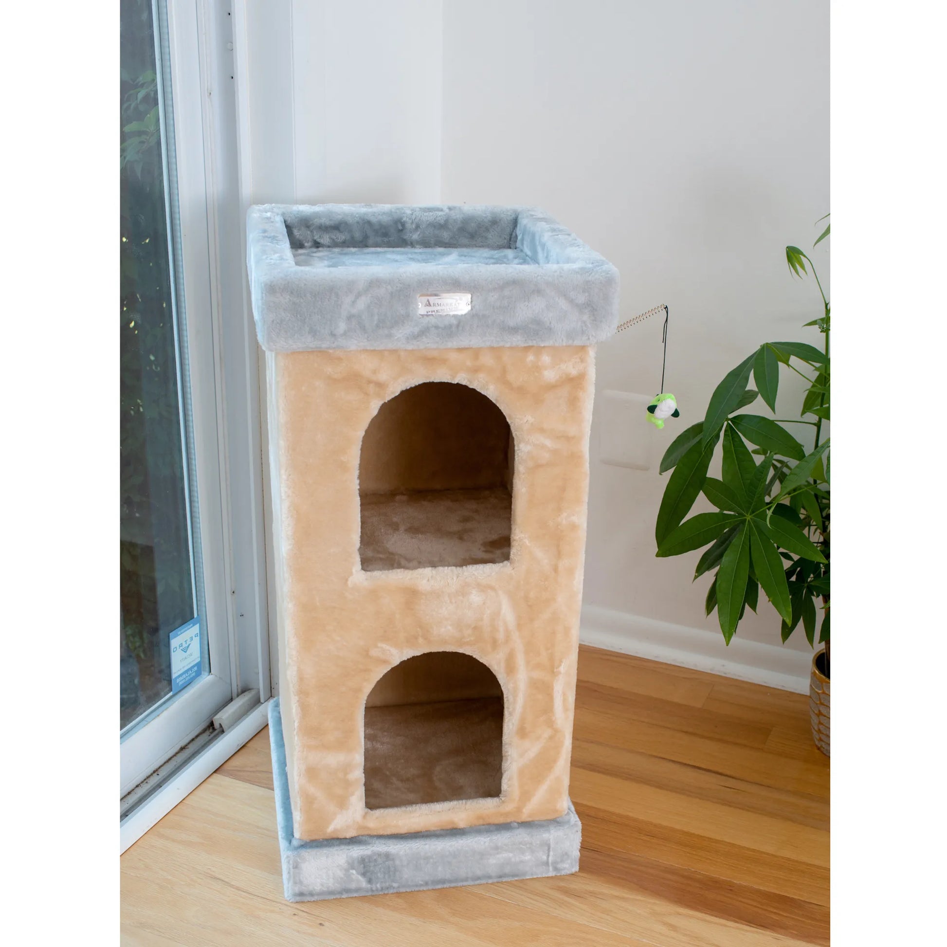 Cat tree with multiple levels and a platform on a wooden floor.