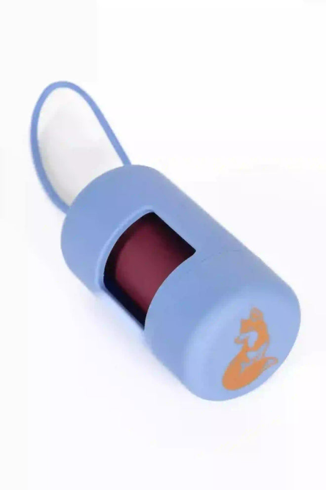 A cornflower blue dog waste bag dispenser with a transparent window and a blue bungee cord attached to it.