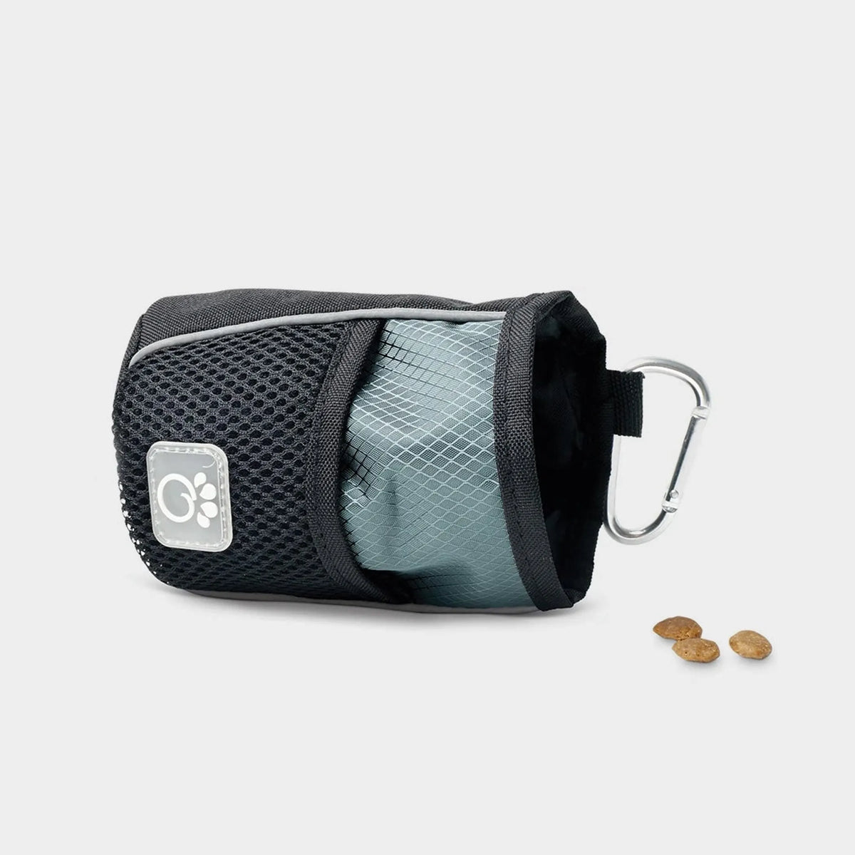 Pet treat pouch with carabiner and treats on a light gray background